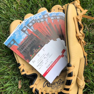 Baseball glove holding Cardinals game tickets